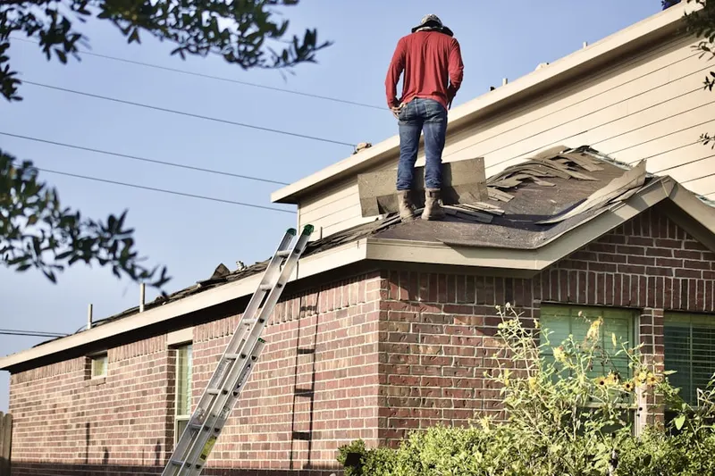 Professional roofer working on a residential roof in Timber Creek Square